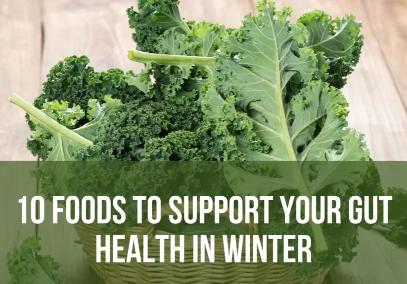 Kale in a basket on wooden table.